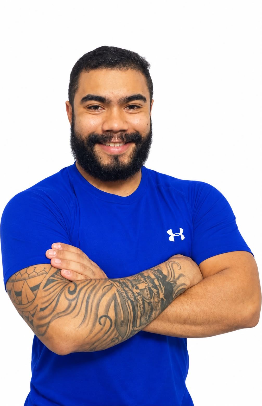 Thiago Santana, personal trainer, sorrindo de braços cruzados
